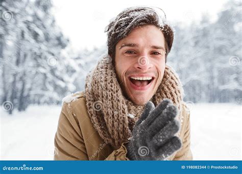 Happy Man Rubbing Hands Smiling Standing In Snowy Forest Stock Photo