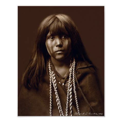 an old black and white photo of a native american woman with long hair wearing necklaces