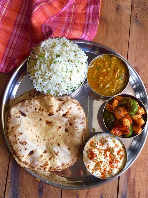 North Indian Food Jeera Rice Dal Tadka Paneer Sabzi Dahi And Roti