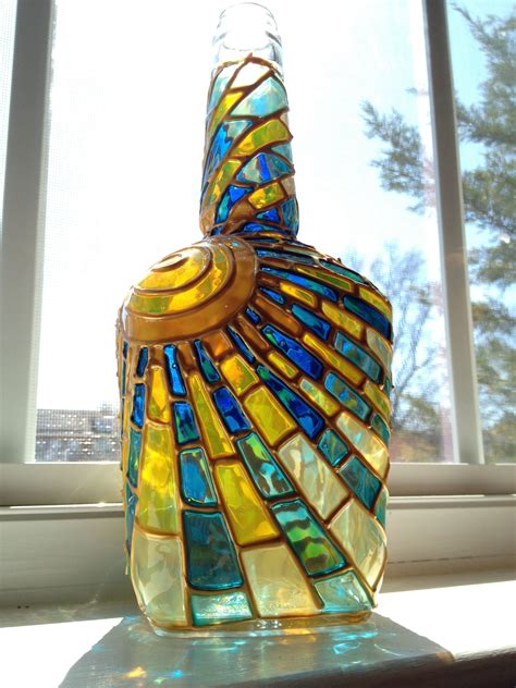 A Colorful Glass Bottle Sitting On Top Of A Window Sill Next To A Window