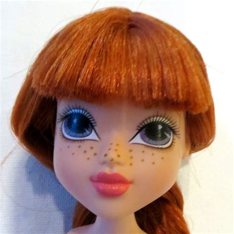 A Doll With Red Hair And Blue Eyes