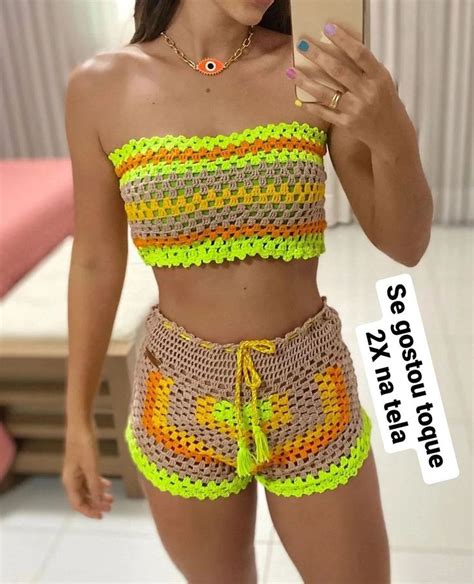 A Woman Taking A Selfie With Her Cell Phone Wearing Crochet Shorts And
