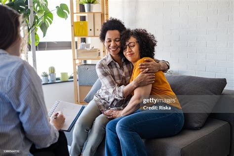 Lesbian Couple Getting Relationship Counseling By Therapist High Res