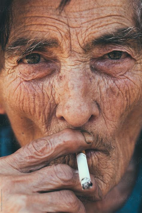 old woman smoking closeup by stocksy contributor borislav zhuykov stocksy