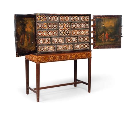 an indo portuguese brass mounted ebony bone ivory and tortoiseshell inlaid cabinet on stand