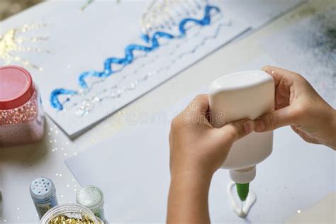 Child S Hands Applying Glue To The Paper Stock Photo Image Of