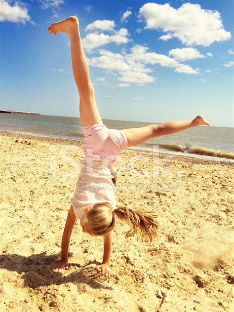 Little Girl Doing A Cartwheel On The Beach Stock Photo Royalty Free