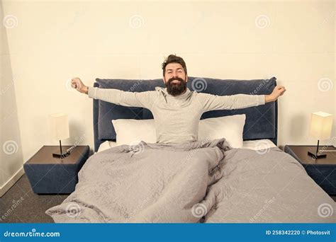 Happy Guy Smiling And Stretching In Bed Waking Up After Sleep Morning