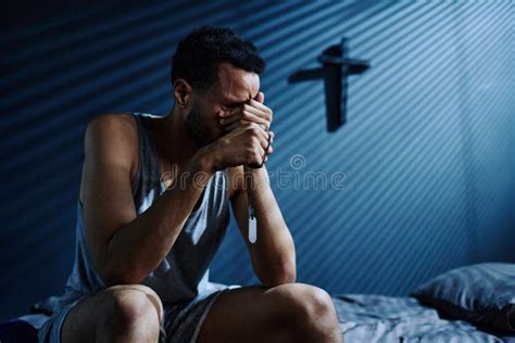 Young Depressed Man Crying Or Grieving About Loss Of Someone He Loved