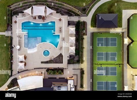 Aerial View Of Large Tennis Courts Swimming Pool At Community