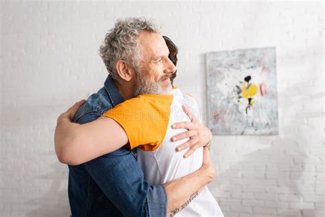 Caucasian Mature Father Embracing Son At Stock Photo Image Of