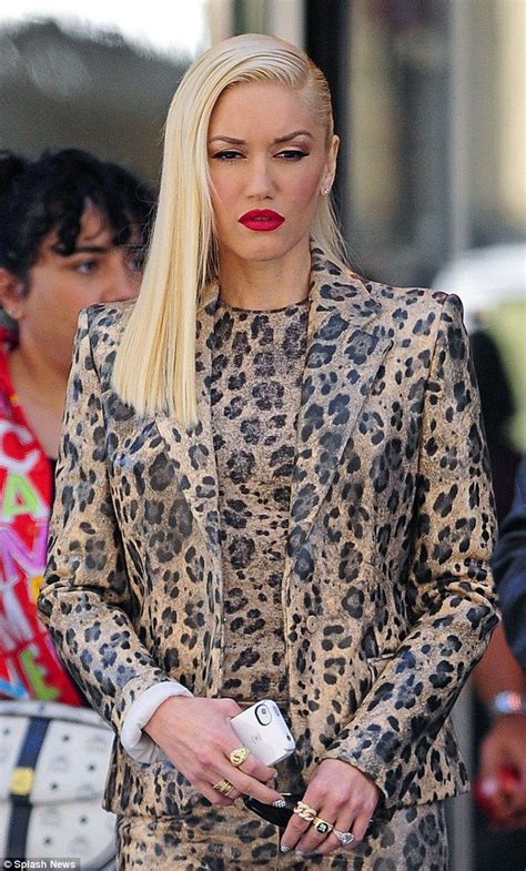 The Blonde Haired Woman Is Dressed In Leopard Print And Red Lipstick
