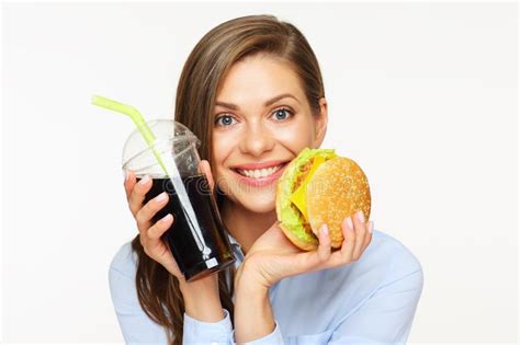 Welcome to laid back burger shack! Portrait Of Surprised Woman Holding Burger With Cola Drink ...