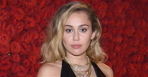 Miley Cyrus Flashes Assets And Tatts In Severely Slashed Dress