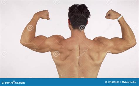 Rearview Shot Of A Muscular Shirtless Man Flexing His Back And Arms
