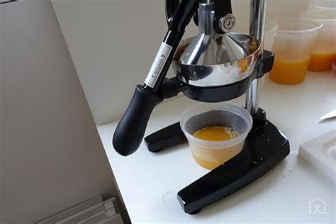 juicer citrus manual press orangex orange juice fruit down holding plastic lever perforated forcing against case container