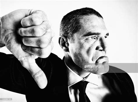 Angry Businessman Gives Emphatic Thumbs Down High Res Stock Photo