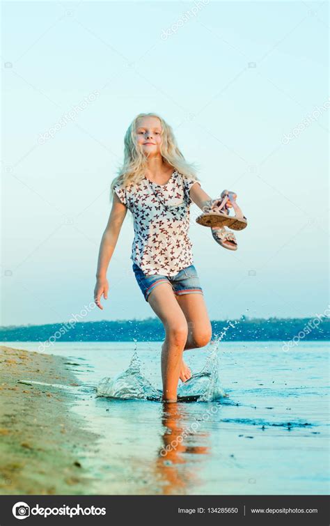 mädchen läuft barfuß am strand am wasser — stockfoto © mikhasik 134285650