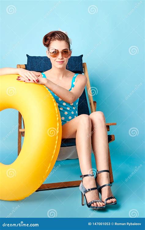 Girl In A Bathing Suit Lying On A Lounger And Holding In Her Arms An Inflatable Circle Royalty