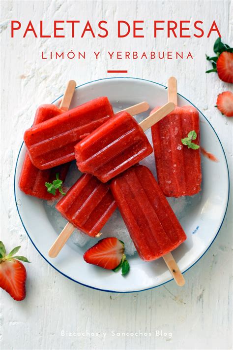 Some Popsicles Are On A Plate With Strawberries Next To It And The