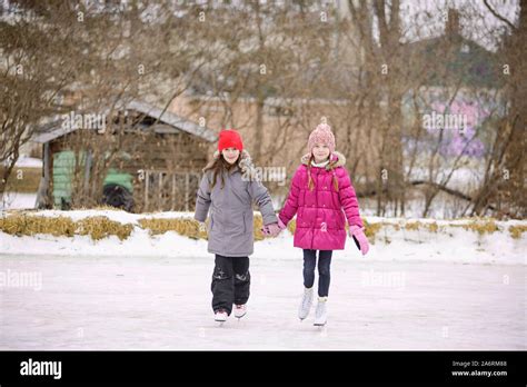 Two Girls Ice Skating Outdoors Stock Photo Alamy