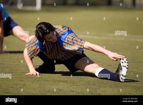 Soccer Player Stretching On Field Stock Photo Alamy