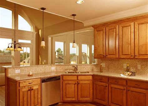 This contemporary kitchen has a light and airy feel with the light wood cabinets and light green backsplash. The Balance between the Small Kitchen Design and ...