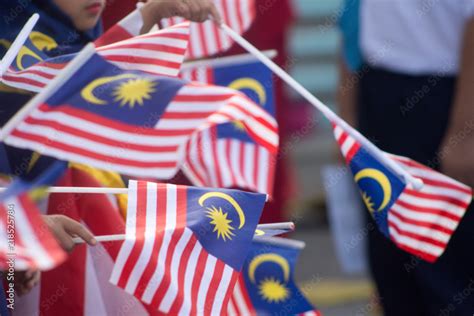 Hand Waving Malaysia Flag Also Known As Jalur Gemilang In Conjunction