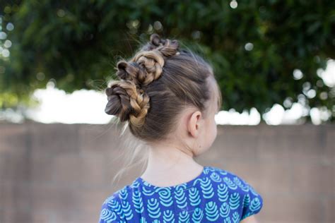 Here, front view hair should rest straight on either the right or left side of the head. Triple Bun Updo | Cute Girls Hairstyles