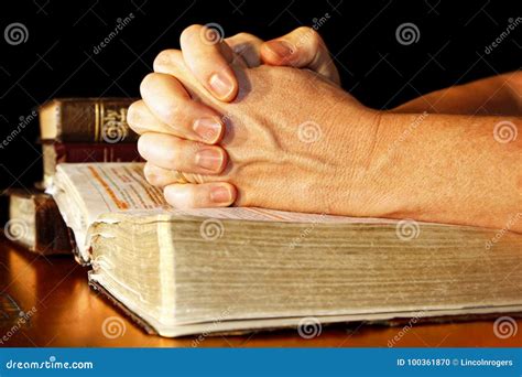 Praying Hands In Light With Holy Bibles Stock Photo Image Of Believe