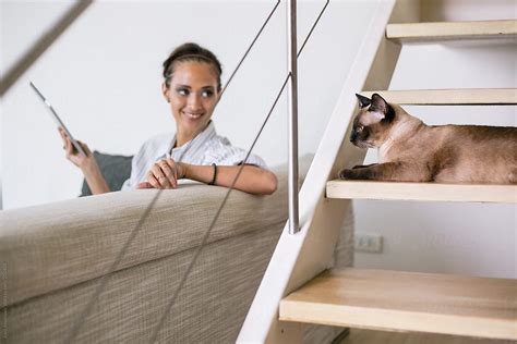 Woman Using Tablet In Her Living Room By Stocksy Contributor Jovo Jovanovic Stocksy