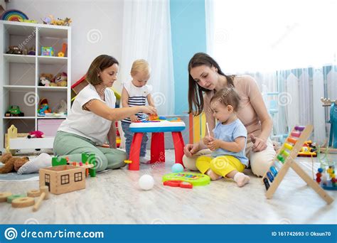 Kids Playing On Floor With Educational Toys Toys For Preschool And