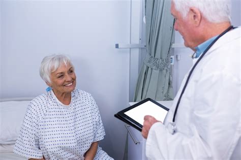 Premium Photo Doctor Interacting With Senior Patient In Ward