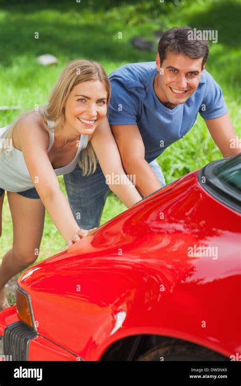 Smiling Couple Pushing Their Broken Down Car Stock Photo Alamy