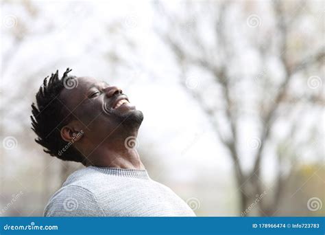 Happy Black Man Breathing Fresh Air Outdoors In Winter Stock Photo