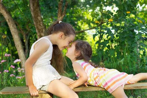 Two Cute Little Girls Playing At The Park Stock Photo Image Of Latino