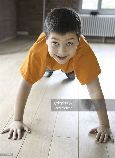 Smiling Boy Doing Pushups Indoors High Res Stock Photo Getty Images