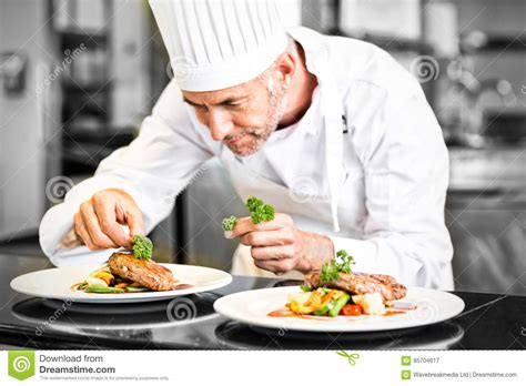 Concentrated Male Chef Garnishing Food In Kitchen Stock Image Image