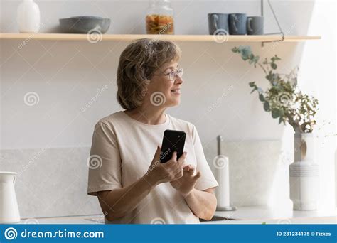 Smiling Dreamy Middle Aged Mature Woman Using Cellphone Stock Image Image Of Happy Older