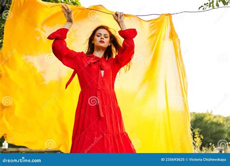 Beautiful Woman Posing In Red Dress Outdoors Yellow Cloth Stock Image