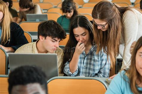 Teacher Helping Students With Assignment Stock Image Image Of Diverse