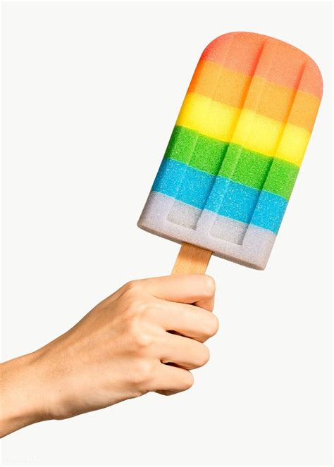 A Hand Holding An Ice Cream Popsicle In Rainbow Colors