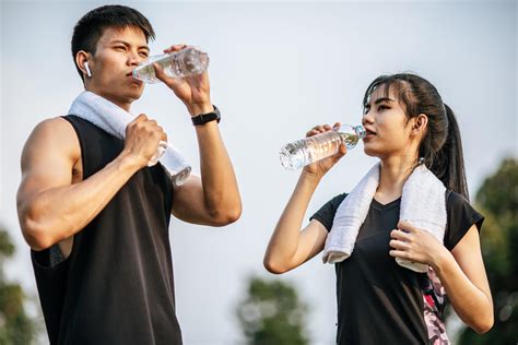Men And Women Stand To Drink Water After Exercise 4890099 Stock Photo