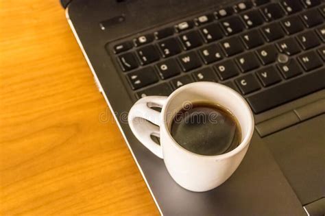 Black Coffee Cup And Laptop Computer On The Background