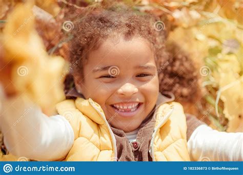 Happy Little Child Baby Girl Laughing And Playing In The Autumn On The