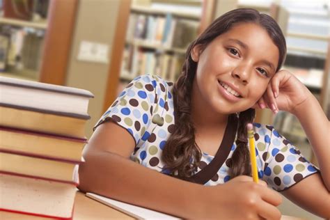 Happy Hispanic Girl Student With Pencil And Books Studying In Library