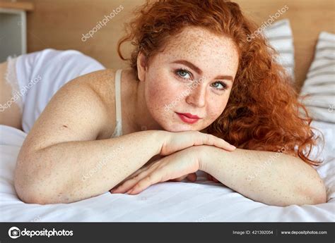 Red Haired Chubby Woman In Lingerie Lies On Bed Have Rest Stock Photo
