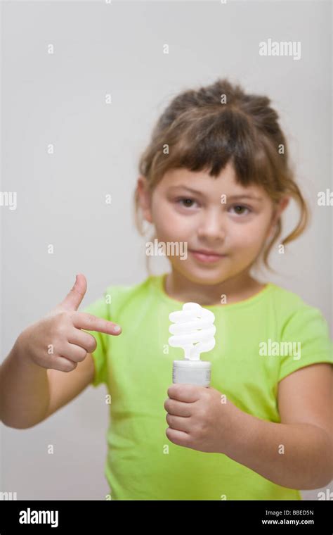 Little Girl Holding Energy Efficient Lightbulb Stock Photo Alamy