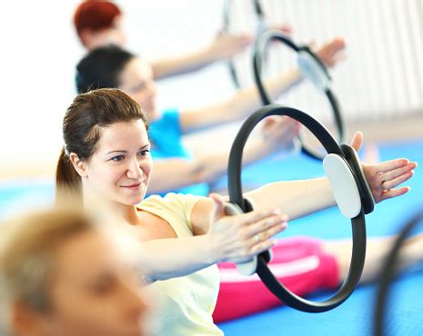 All levels and abilities welcome. Group Of Women In Pilates Class Stock Photo - Download ...