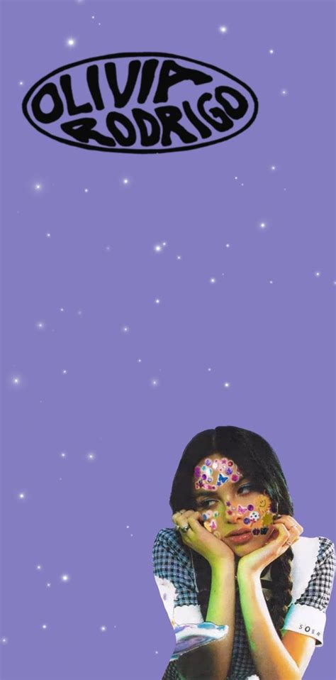 A Girl With Sprinkles On Her Face Sitting In Front Of A Purple Background